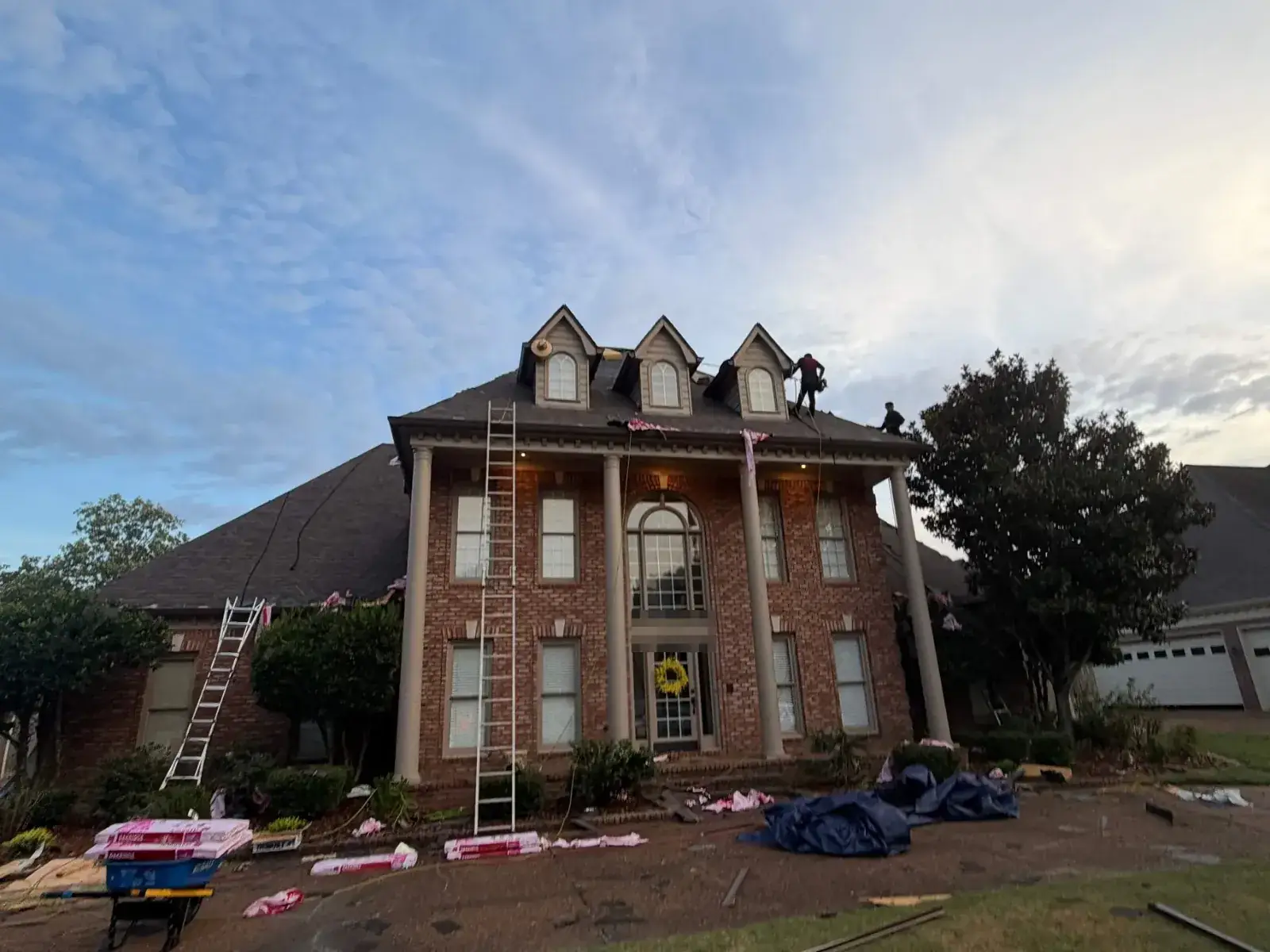 Metro crew roofing a two-story colonial home