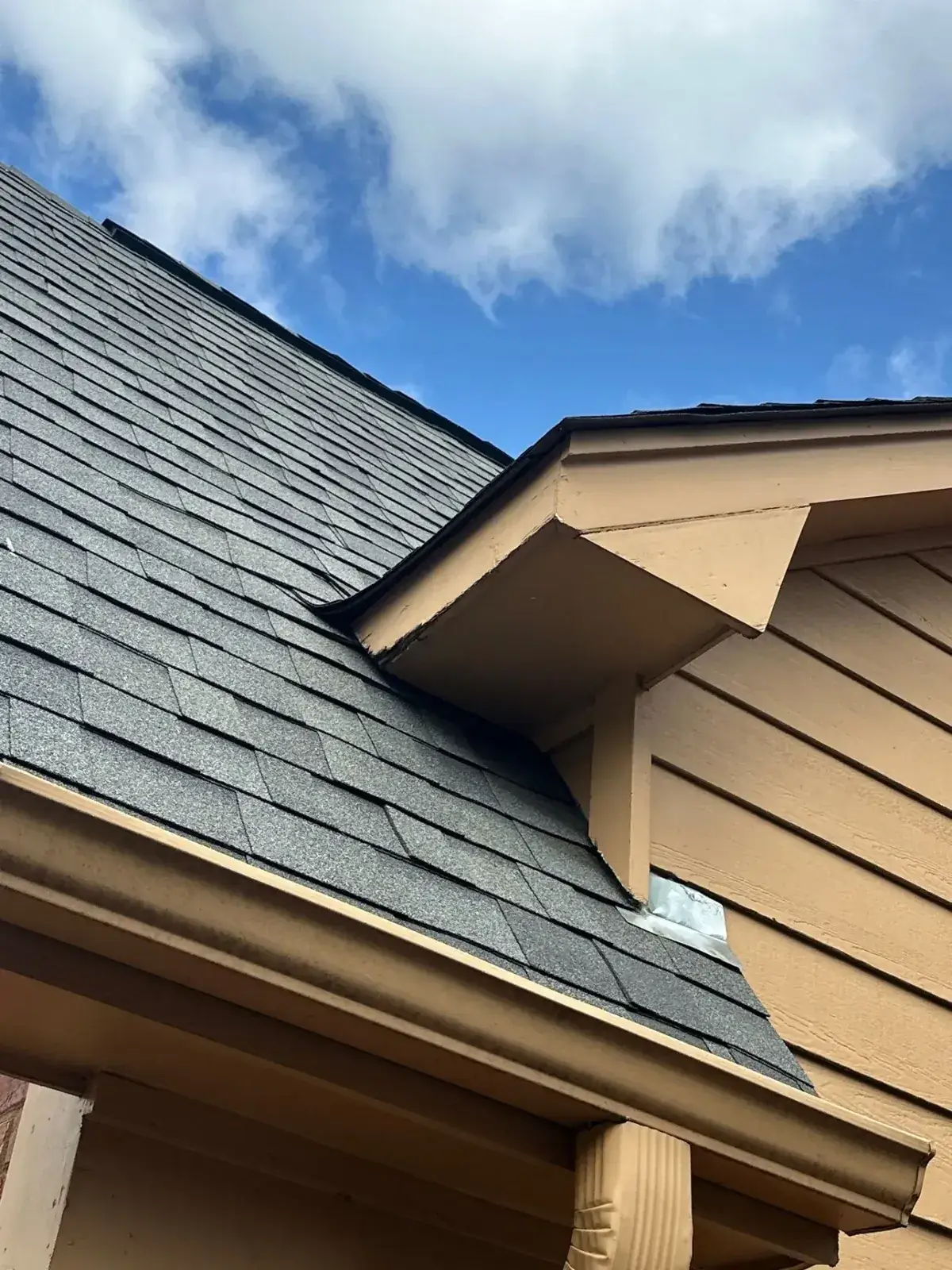 Close-up of new shingles meeting a dormer