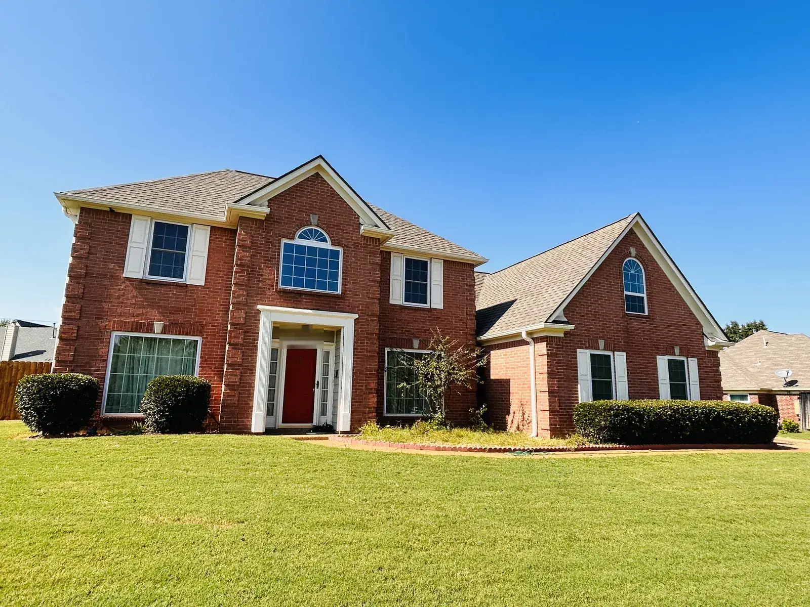Two-story brick home with a new roof