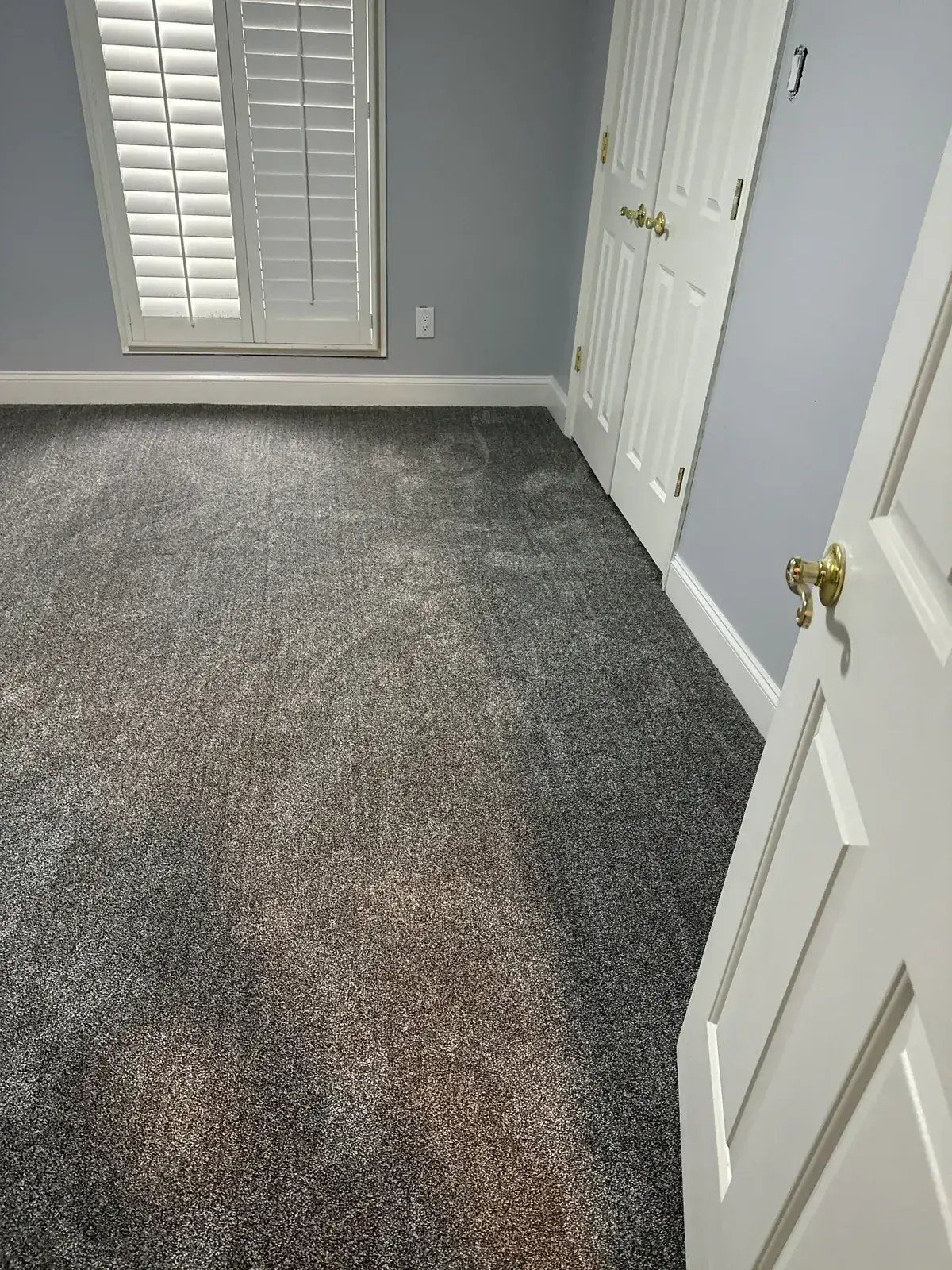 Restored bedroom with new plush carpet, fresh paint and trim, plantation shutters
